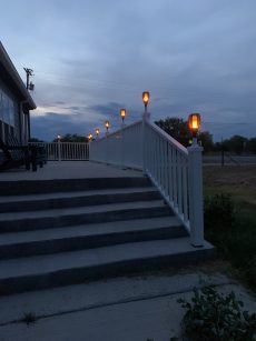 4x4 Vinyl Post Cap Showing Flickering Solar Lights from TomCare on Deck Railing at Dusk
