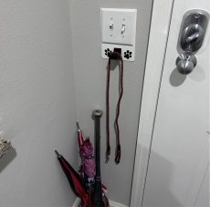 2 gang universal fit dog leash holder for wall mount for underneath outlet wall plate with paw prints - showing use