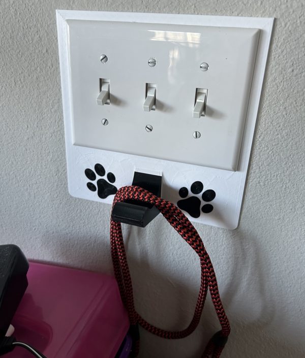3 gang universal fit dog leash holder for wall mount for underneath outlet wall plate with paw prints - showing use